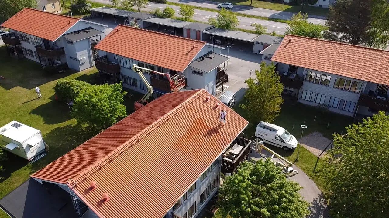 Skylift vid tegeltak under taktvätt, drönarbild